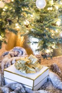 Holiday Gift Guide, Christmas Tree. Christmas Gift Ideas, white and gold gift box, gold bow, and an antelope throw blanket create a glam Christmas look. Find the perfect Christmas Gift Ideas For Everyone On Your List
