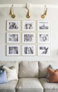 Creating a Grid Style Gallery Wall with these easy tips and tricks. Brass matted picture frames, brass swing arm sconces turned into a gallery wall creates the perfect backdrop for our sofa.