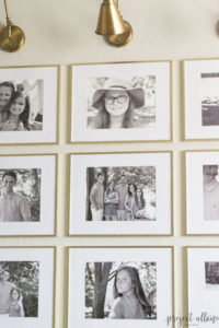 Creating a Grid Style Gallery Wall with these easy tips and tricks. Brass matted picture frames, brass swing arm sconces turned into a gallery wall creates the perfect backdrop for our sofa.
