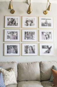 Creating a Grid Style Gallery Wall with these easy tips and tricks. Brass matted picture frames, brass swing arm sconces turned into a gallery wall creates the perfect backdrop for our sofa.