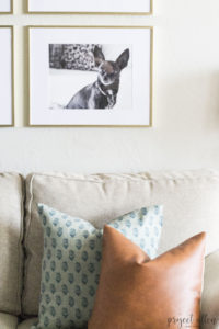 Creating a Grid Style Gallery Wall with these easy tips and tricks. Brass matted picture frames, brass swing arm sconces turned into a gallery wall creates the perfect backdrop for our sofa.