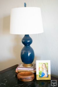Welcome to our Spring Home Tour: See how we transformed our home with just a few simple changes, a brass frame gallery wall with gold swing arm sconces frame this neutral sofa adorned with mudcloth and leather pillows.