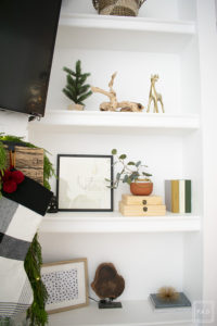 A snowy flocked Christmas tree decorated in red, green and gold gives a big dose of nostalgia to this modern farmhouse living room.