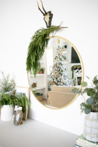A flocked Christmas tree decorated in red, green and gold gives a big dose of nostalgia to this modern farmhouse living room.