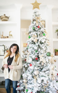 A flocked Christmas tree decorated in red, green and gold gives a big dose of nostalgia to this modern farmhouse living room.