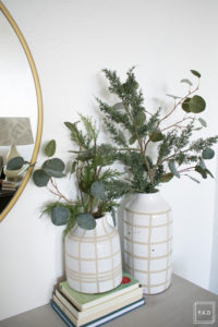 A snowy flocked Christmas tree decorated in red, green and gold gives a big dose of nostalgia to this modern farmhouse living room.