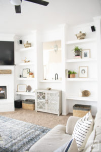 breath of fresh air spring home tour: white built-ins decorated with neutral decor mixed with a few pops of color.