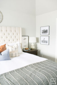 breath of fresh air spring home tour: California cool master bedroom complete with a tufted grand headboard, pattern mixed pillows and tribal rug.
