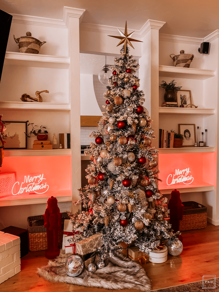 A Modern Christmas living room Decorated with a red neon Merry Christmas sign
