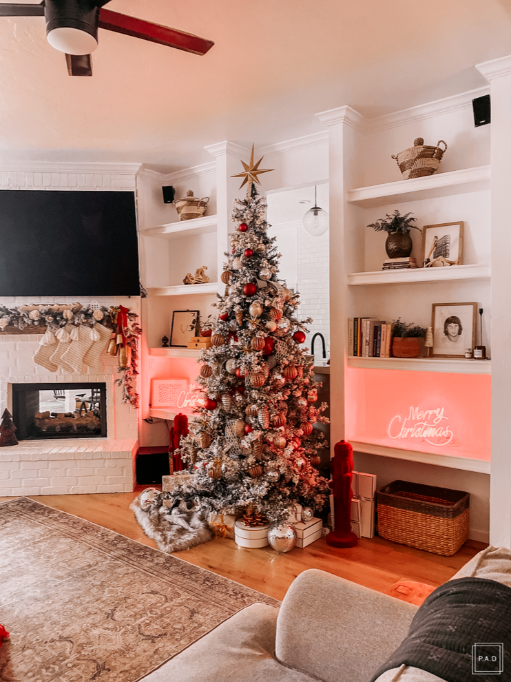 A Modern Christmas living room Decorated with a red neon Merry Christmas sign